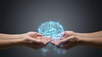 Digital brain hologram floating above cupped hands representing artificial intelligence, machine learning, and cognitive technology concepts.