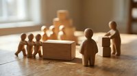 Wooden figurines working together to move and stack blocks on a table, symbolizing teamwork, collaboration, and business leadership concepts.