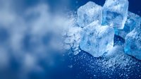 Crystalline ice cubes with frost coating on blue background with scattered ice particles, suitable for beverage, food and drink advertising.