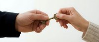 Two hands exchanging golden key in professional handover gesture symbolizing trust, partnership, real estate transaction, business deal completion.