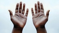 Two open hands with palms facing up in gesture of receiving, offering or prayer isolated on white background for design use.