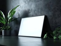 Laptop computer with blank white screen on dark desk surrounded by potted green plants and textured gray wall background for mockup and design projects.