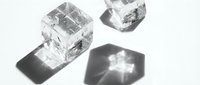 Clear ice cubes with dramatic shadows on white background for beverage photography and cooling concepts in commercial design projects.