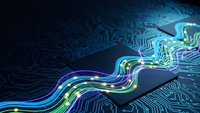 Abstract digital circuit board with glowing neon data streams flowing through electronic pathways in blue and green colors for technology concepts.