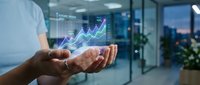 Businessman holding holographic financial growth chart with upward trending arrow in modern office environment for business analytics and data visualization.
