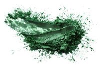 Green cosmetic powder explosion with dynamic motion effect and scattered particles on white background, makeup and beauty concept for design projects.
