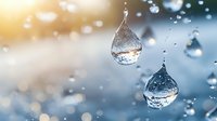 Suspended water droplets with golden sunlight creating bokeh effect, capturing nature's purity and environmental concept in macro photography.