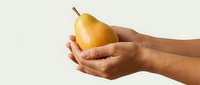 Fresh ripe pear held gently in cupped hands against clean background showcasing natural organic fruit for healthy eating and nutrition concepts.
