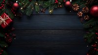 Christmas border with fir branches, red ornaments, pine cones, and gift box on dark wooden background, creating festive frame with copy space.