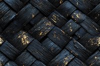 Weathered black wooden planks in diagonal pattern with distressed gold accents creating rustic texture background for design projects and creative layouts.