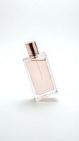 Elegant glass perfume bottle with rose gold cap containing pink fragrance liquid on white background for cosmetic and beauty product design.