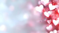 Romantic pink and white hearts floating on soft blurred background with bokeh effect creates dreamy atmosphere for Valentine's Day or wedding designs.