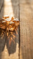 Golden polyhedral dice set on rustic wooden table with warm sunlight creating dramatic shadows for tabletop gaming and role-playing adventures.
