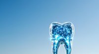 Transparent tooth-shaped container filled with glowing blue liquid and particles against clear sky background, suitable for dental care, oral health, and medical marketing materials.