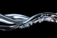 Elegant flowing water stream with floating transparent bubbles against black background creates dynamic wave pattern for luxury design projects.
