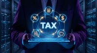 Professional businessman holding holographic tax interface with financial icons in futuristic digital environment for accounting and finance technology solutions.