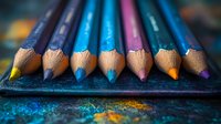 Colorful wooden pencils arranged in row on dark textured surface with glitter sparkles, macro photography showing detailed wood grain texture and sharp tips.
