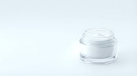 Open white cosmetic cream jar with lid removed on clean white background for skincare and beauty product packaging design.
