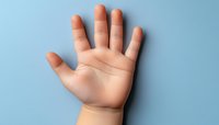 Close up of baby's open palm and chubby fingers against light blue background, showing delicate skin texture and natural life lines. Perfect for childcare and parenting concepts.