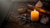 Mystical altar setup with burning candle, crystals, ancient books and occult symbols for spiritual rituals and esoteric practices.