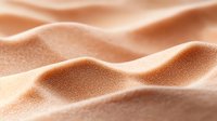 Smooth sandy dunes with gentle waves and curves creating abstract natural pattern in warm beige tones, macro photography with soft shadows and highlights.