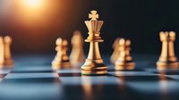 Golden chess king piece standing on chessboard with blurred pawns in background, dramatic lighting creates strategic business leadership atmosphere.