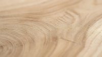 Close-up of light wood grain texture showing natural rings and growth patterns, suitable for backgrounds, flooring design, furniture mockups, and woodworking projects.