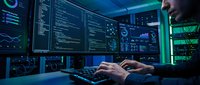 Cybersecurity analyst monitoring network security systems with multiple screens displaying code and data analytics in modern control room.