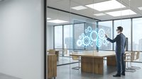 Professional businessman in suit interacting with holographic digital interface displaying gear icons in modern glass-walled office conference room.