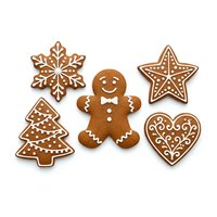 Gingerbread cookies with white icing decoration isolated on white background. Includes snowflake, star, tree, gingerbread man and heart shapes for holiday baking and festive designs.