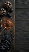 Black garlic bulbs with cocoa powder and black beans on rustic wooden cutting board, healthy superfood ingredients for gourmet cooking and natural wellness recipes.