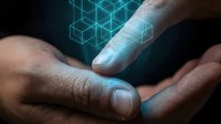 Hands of male with medium skin tone exchanging glowing geometric holographic data visualization, representing digital technology transfer, innovation, and futuristic business collaboration.