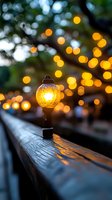 Glowing lantern on wooden railing at dusk with magical bokeh lights creating warm atmospheric mood, shallow depth of field captures dreamy evening ambiance.