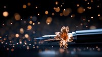 Elegant fountain pen nib with decorative golden flower detail against dark background with magical bokeh lights creating dreamy artistic atmosphere.