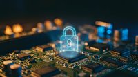 Cybersecurity concept with glowing padlock hologram over computer circuit board representing data protection and digital security technology.