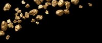 Golden nuggets scattered on black background with copy space for mining and precious metals concept.