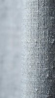 Close-up of gray linen fabric texture with natural weave pattern and soft focus background for interior design and textile projects.