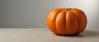 Fresh orange pumpkin on neutral background for autumn harvest decoration and seasonal cooking recipes.