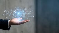 Person in dark business suit holding glowing digital globe network with connected icons, representing global technology, data connectivity, and digital transformation for business solutions.