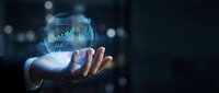 Businessman hand holding glowing digital globe with financial charts and data analytics for business growth, investment, and global commerce concepts.