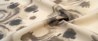 Beige fabric with abstract brown and gray watercolor stains and organic flowing patterns, suitable for textile design and fashion backgrounds.