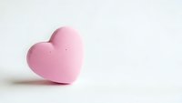Pink heart-shaped object on white background for Valentine's Day, love, romance and relationship concepts in minimalist style.