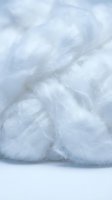 Close-up of fluffy white cotton fibers with soft texture and delicate strands. Suitable for healthcare, wellness, hygiene, and beauty product packaging and advertising.