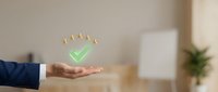 Business professional hand presenting green checkmark with golden stars rating system for quality service evaluation and customer satisfaction feedback.