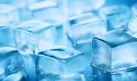 Frozen ice cubes with water droplets and condensation in cool blue tones, perfect for beverage advertisements and cooling concepts.