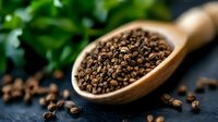 Aromatic black peppercorns in wooden spoon with scattered peppercorns on dark background and fresh herbs, macro food photography for cooking and seasoning.