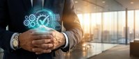 Professional businessman in suit holding glowing digital quality control checkmark with gears in modern office environment with city skyline background.