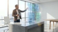 Professional businessman in suit presenting holographic digital interface technology in modern office conference room with city view windows.