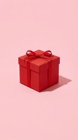 Red gift box with ribbon bow on pink background for holiday celebrations and special occasions.