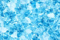 Bright blue frozen ice crystals background with cracked texture and white highlights creates dynamic winter pattern for seasonal designs and cold concepts.